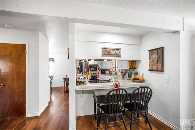 a view of a dining room with furniture and wooden floor