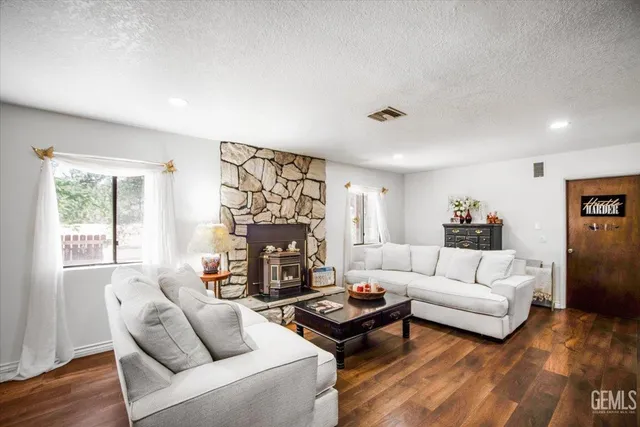 a living room with furniture a fireplace and a flat screen tv