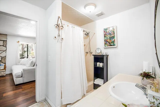 a en suite bathroom with a sink and a large mirror