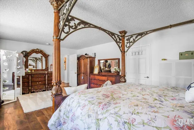 a bedroom with a bed and a mirror on dresser