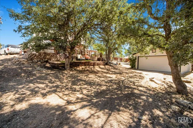 a backyard of a house with large trees