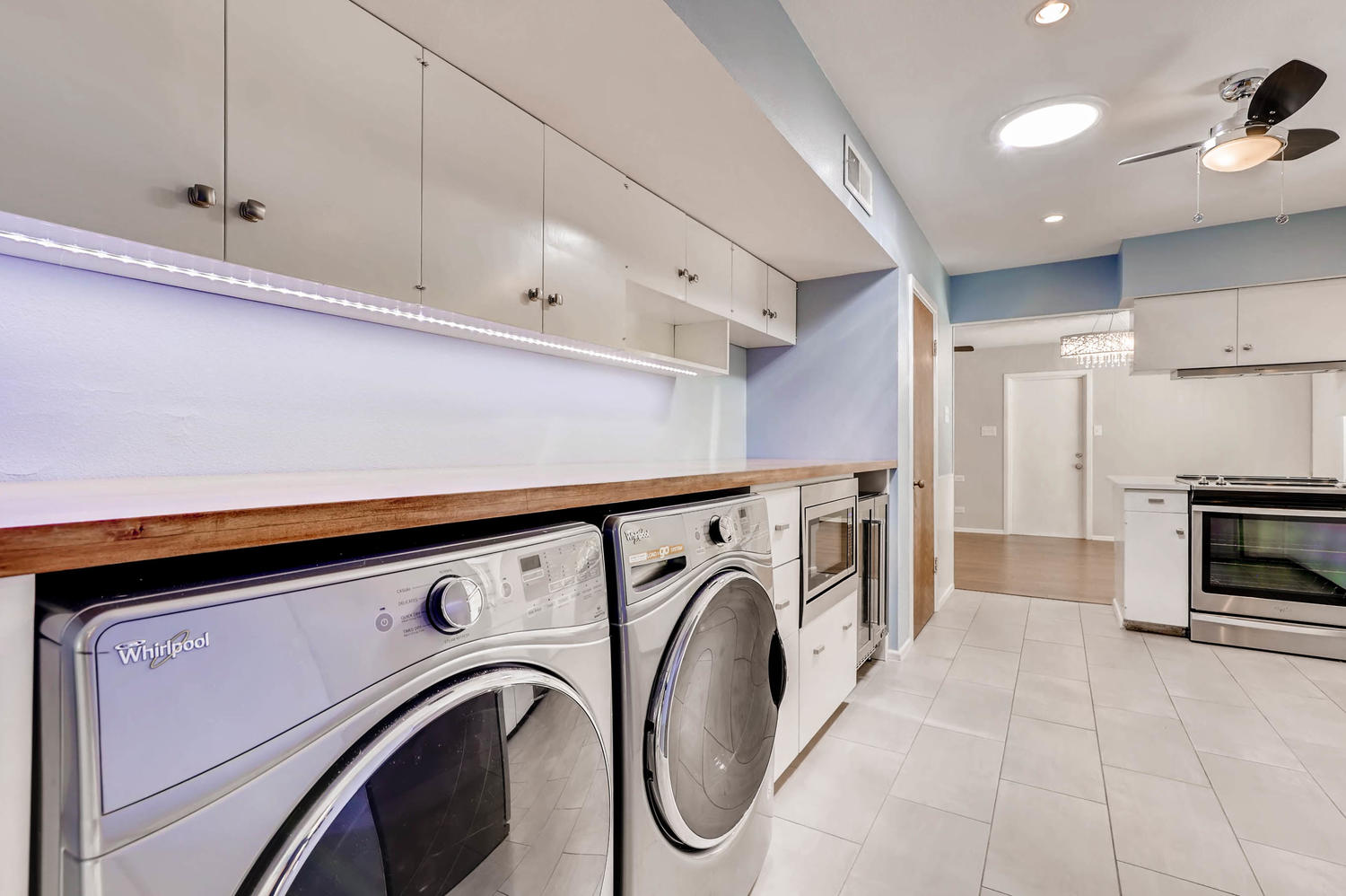 446 Pike Road San Antonio, TX 78209 - Photo 20 of 28 Functional utility space with ample counter, storage, and modern laundry appliances for daily convenience.