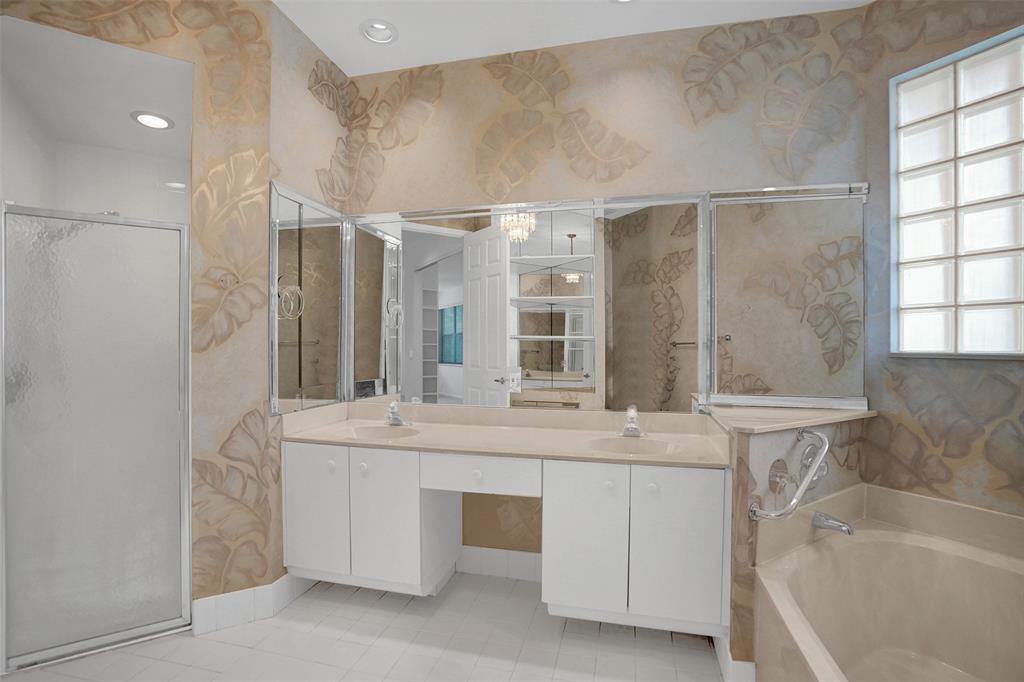 6463 Colomera Drive Boca Raton, FL 33433 - Photo 15 of 29 a bathroom with a double vanity sink a mirror and a bathtub