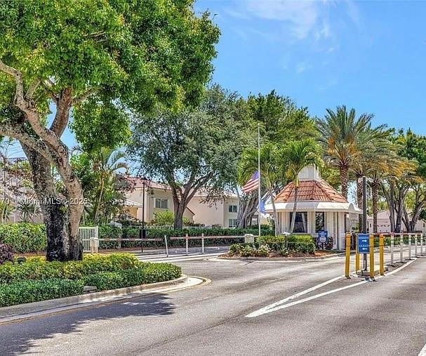 6463 Colomera Drive Boca Raton, FL 33433 - Photo 29 of 29 a front view of a house with a garden and trees