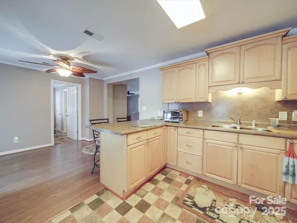 a kitchen with granite countertop cabinets stainless steel appliances a sink and a window