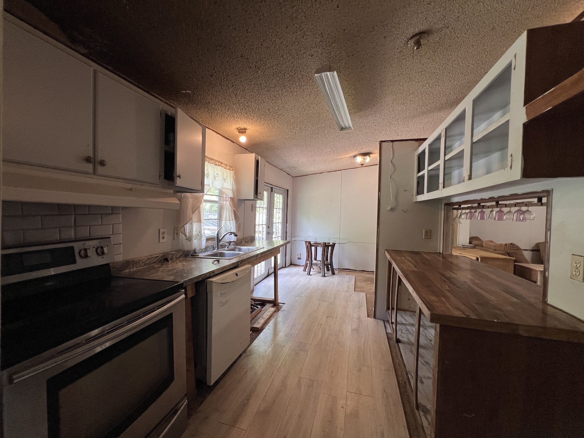616 Powell Street Paris, TN 38242 - Photo 13 of 26 a kitchen with stainless steel appliances granite countertop a stove and a sink