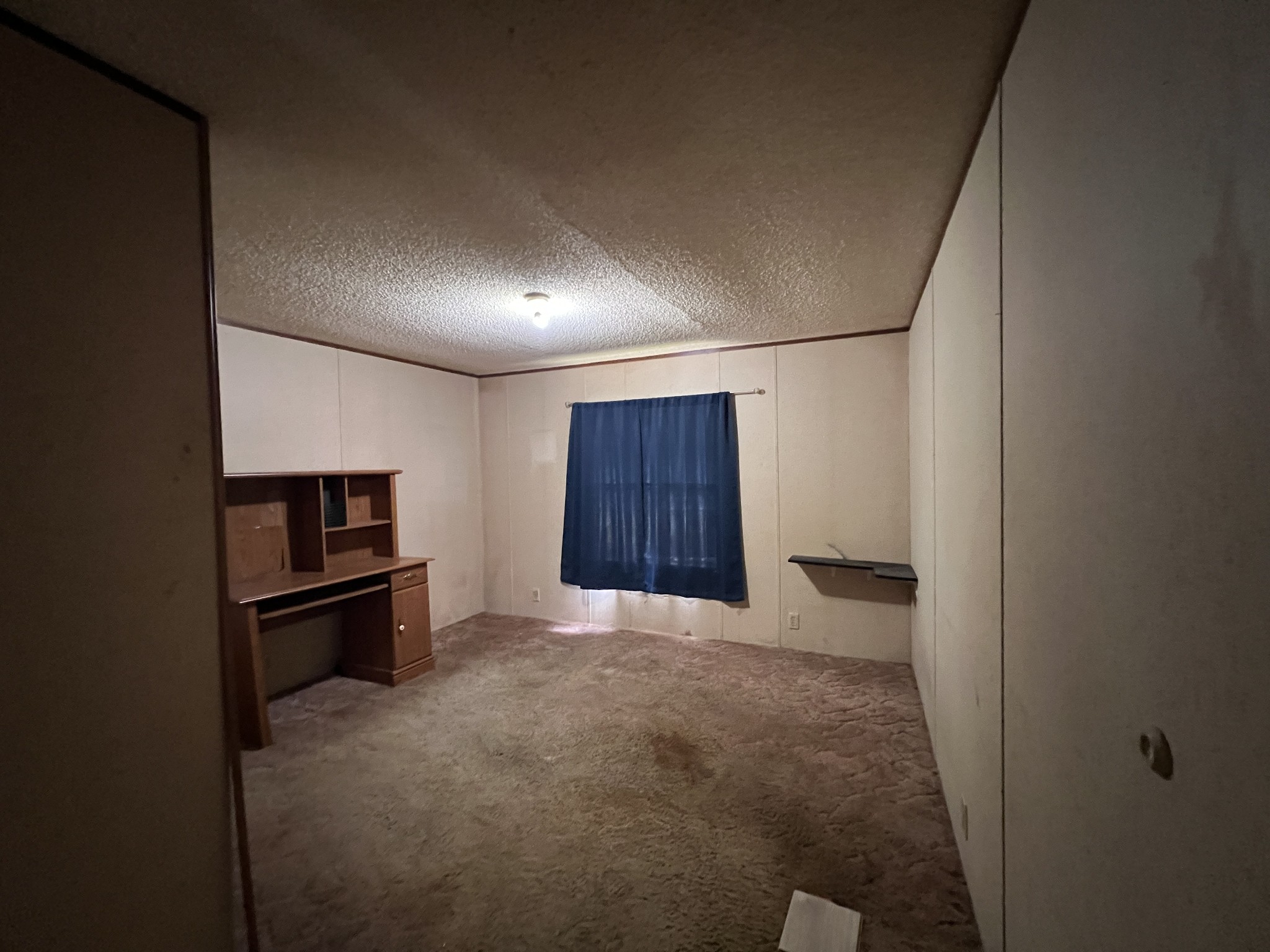 616 Powell Street Paris, TN 38242 - Photo 17 of 26 a view of an empty room with a kitchen