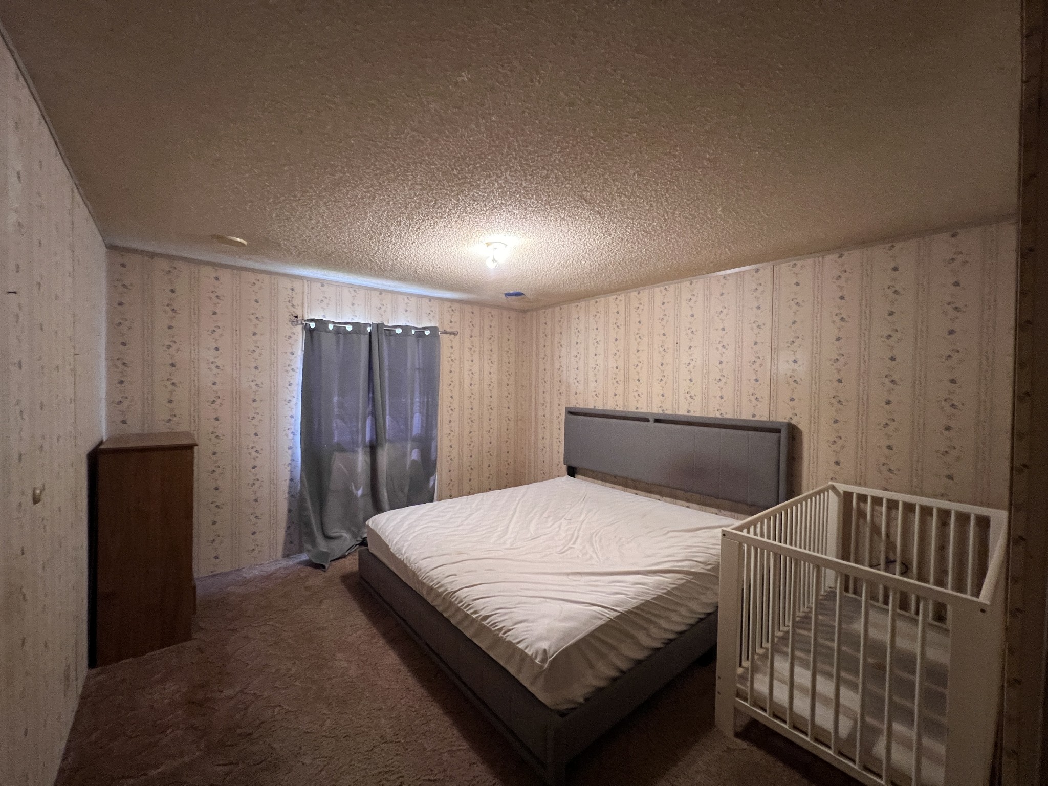 616 Powell Street Paris, TN 38242 - Photo 23 of 26 a bedroom with a bed and wooden floor