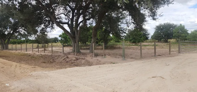 a view of a backyard with wooden fence