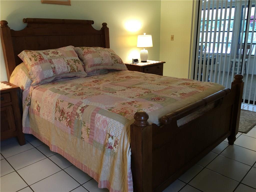95 South Sewalls Point Road Stuart, FL 34996 - Photo 16 of 30 a bed sitting in a bedroom next to a window