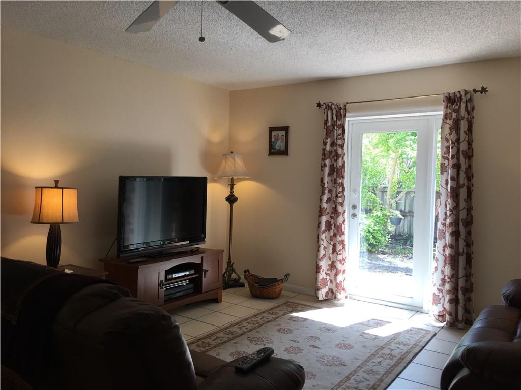 95 South Sewalls Point Road Stuart, FL 34996 - Photo 8 of 30 a living room with furniture and a flat screen tv