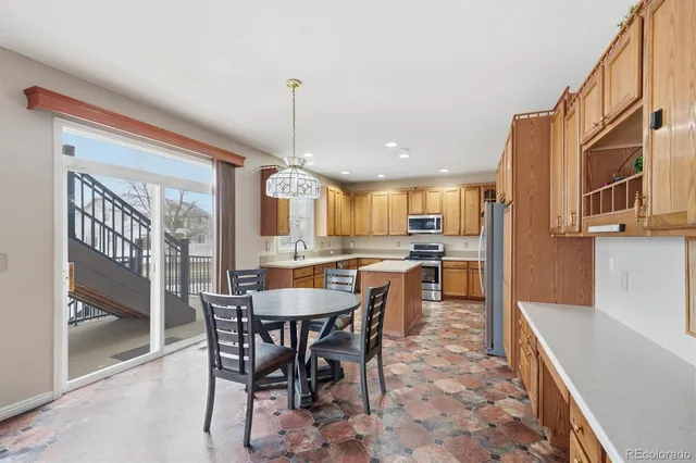 a view of a dining room and livingroom with furniture wooden floor a chandelier