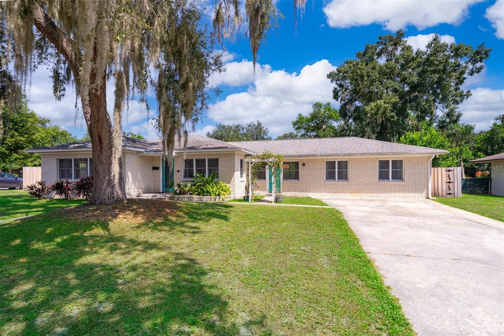 2187 Palmetto Road Mount Dora, FL 32757 - Photo 1 of 1 a front view of house with yard and green space