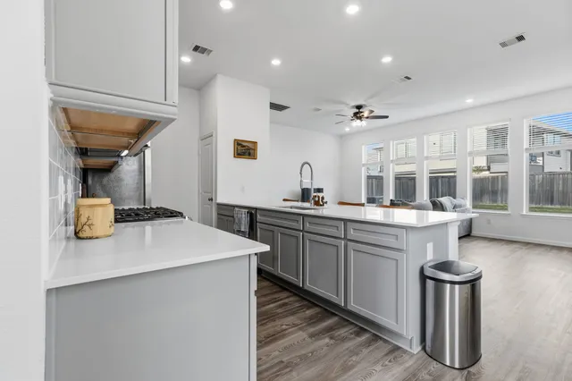 a kitchen with sink cabinets and stove