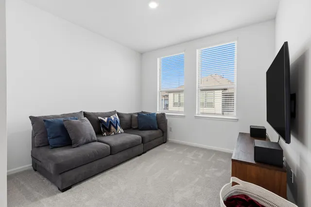 a view of a house with a yard and a large tree