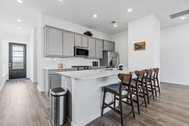 a kitchen with a dining table chairs and microwave