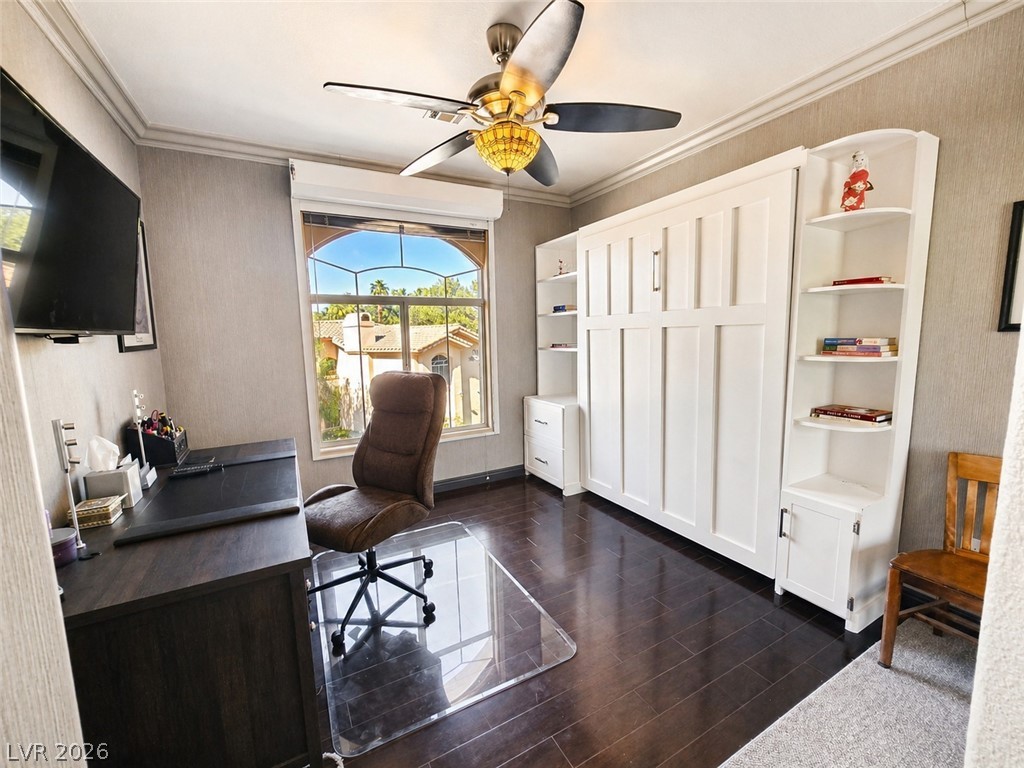 2050 West Warm Springs Road, Unit 2422 Henderson, NV 89014 - Photo 28 of 44 This versatile space features rich wood flooring, crown molding, and a beautiful arched window with outdoor views.