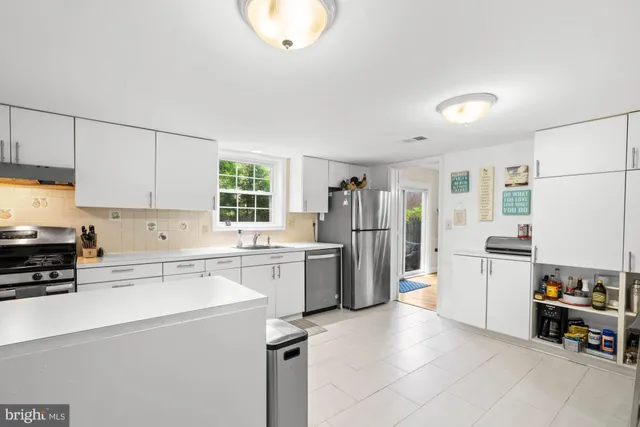 a kitchen with a sink stove and cabinets