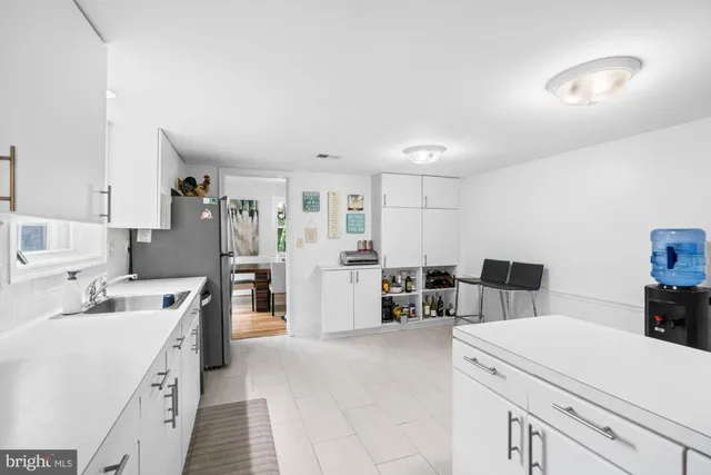 a view of kitchen with refrigerator and furniture