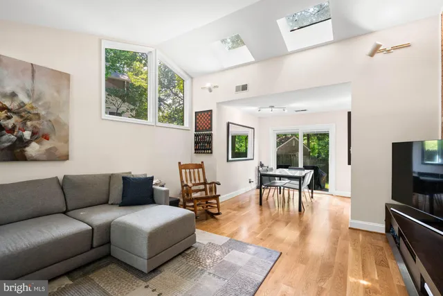 a view of a workspace with furniture and wooden floor