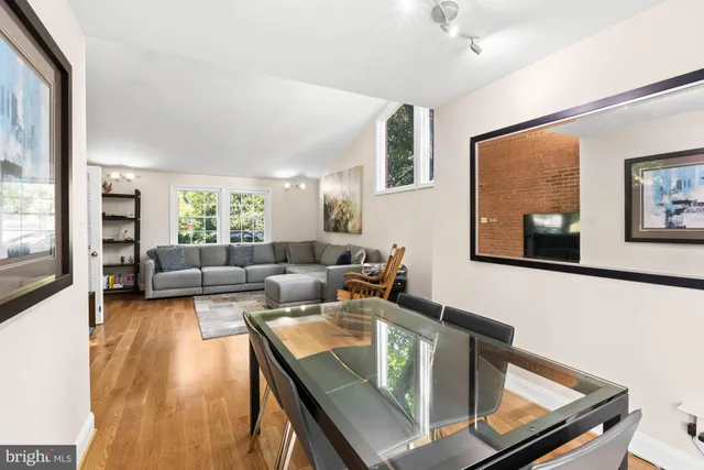 a view of a dining room with furniture a chandelier and wooden floor
