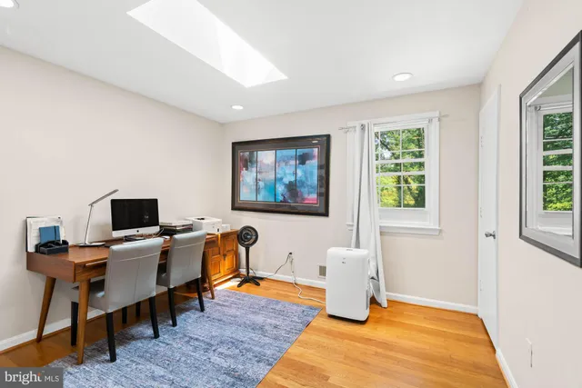 a dining room with furniture a chandelier and wooden floor