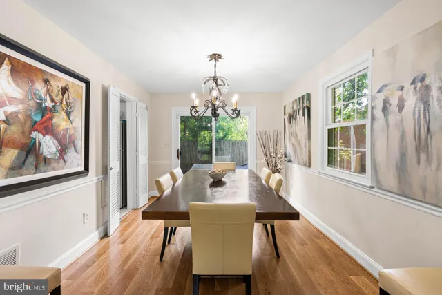 a bedroom with a bed and a lamp on dresser