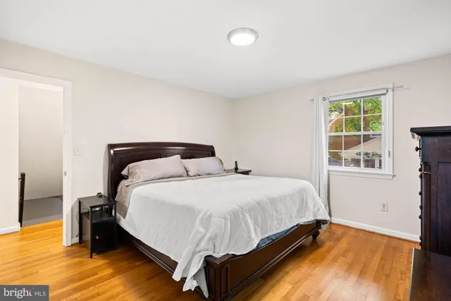 a living room with furniture and a book shelf