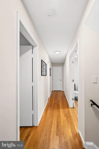 a view of a tiny house with a small yard and large trees