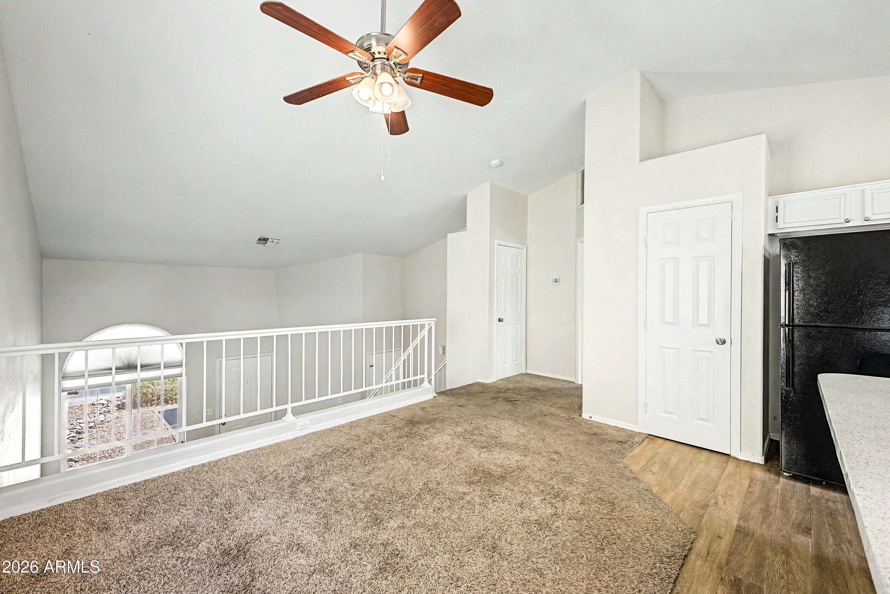 3134 East McKellips Road, Unit 221 Mesa, AZ 85213 - Photo 6 of 29 an empty room with staircase and a ceiling fan