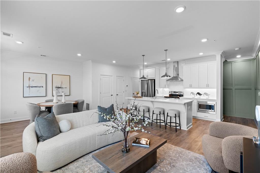 a living room with furniture and kitchen view