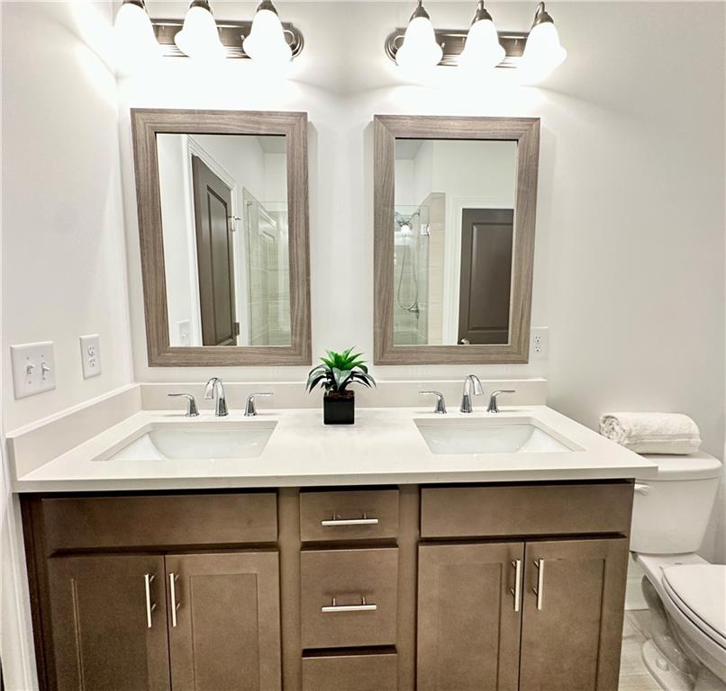 518 Alice Way, Unit D13 Cumming, GA 30040 - Photo 17 of 51 a bathroom with a double vanity sink and a mirror