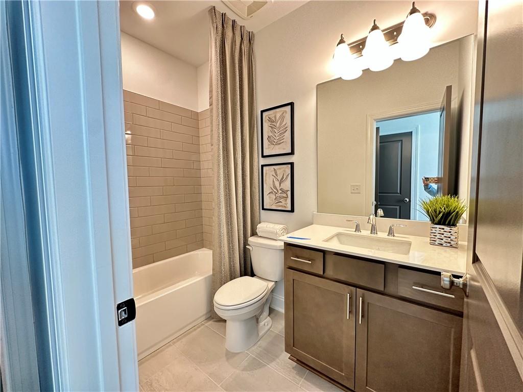 518 Alice Way, Unit D13 Cumming, GA 30040 - Photo 20 of 51 a bathroom with a toilet a sink and a mirror