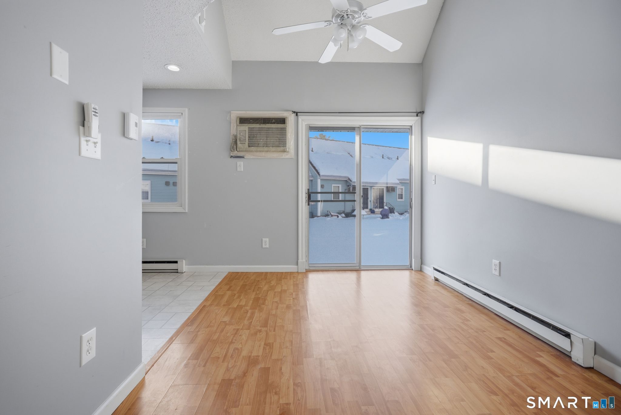1 Abbott Road, Unit 44 Ellington, CT 06029 - Photo 5 of 18 Cathedral ceiling with paddle fan. Sliders to the back.