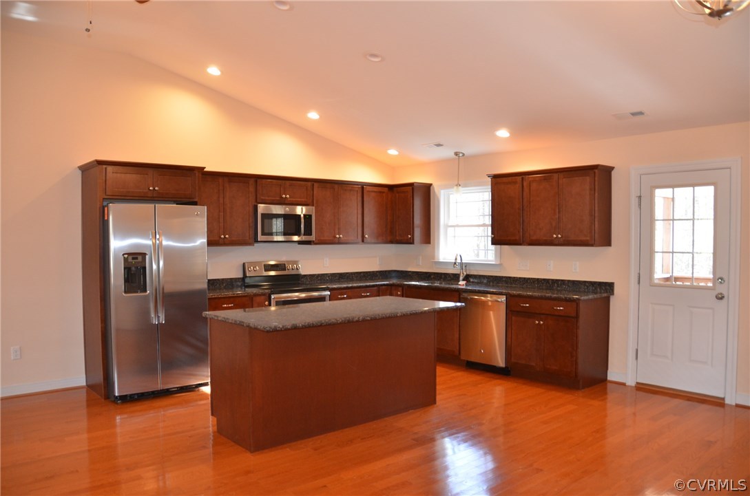 1118 Signboard Road Bumpass, VA 23024 - Photo 4 of 26 a kitchen with stainless steel appliances granite countertop a stove a sink and a refrigerator with wooden floor