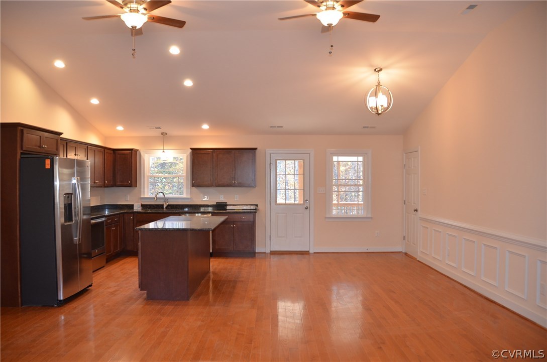 1118 Signboard Road Bumpass, VA 23024 - Photo 5 of 26 a kitchen with stainless steel appliances kitchen island granite countertop a refrigerator a stove a sink and a refrigerator with wooden floor