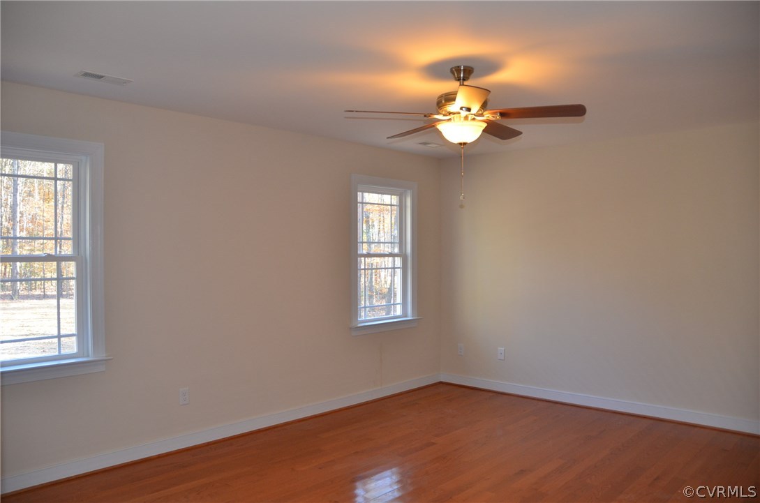 1118 Signboard Road Bumpass, VA 23024 - Photo 9 of 26 an empty room with windows and fan