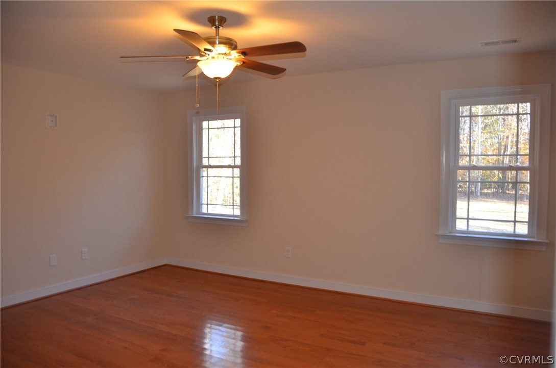 1118 Signboard Road Bumpass, VA 23024 - Photo 10 of 26 a view of an empty room with wooden floor and a window