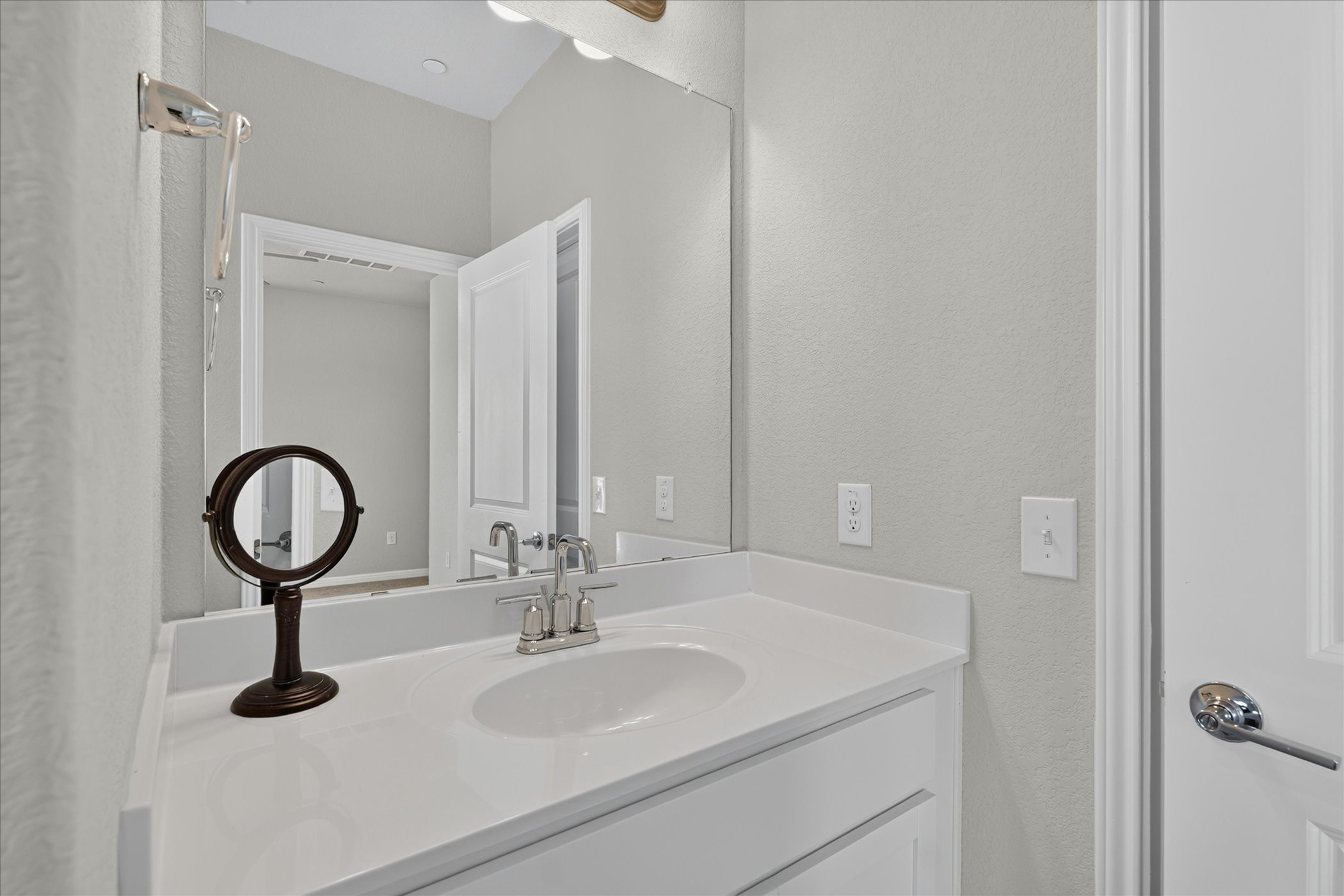 9015 Cattle Baron Path, Unit 1102 Austin, TX 78747 - Photo 20 of 25 Modern bath features a pristine vanity with integrated sink and generous mirror.