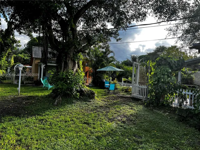 a view of an house with backyard space and sitting area