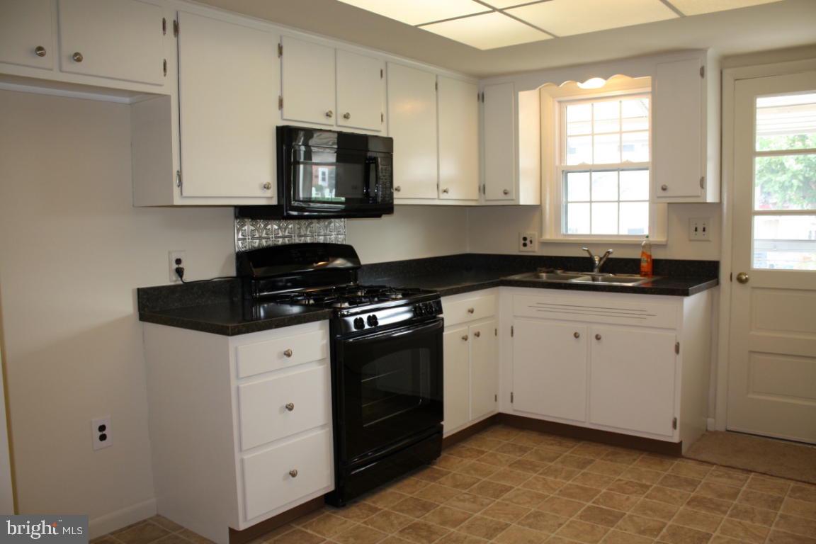 503 West Marion Street Lititz, PA 17543 - Photo 6 of 10 a kitchen with white cabinets granite counter tops and a stove