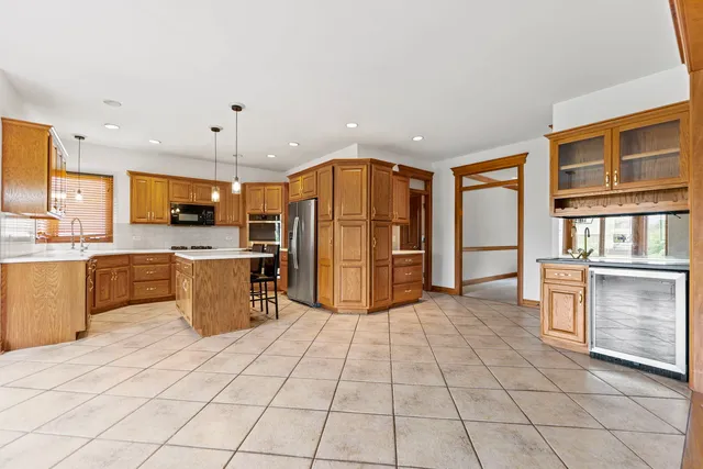 a kitchen with stainless steel appliances a refrigerator sink and cabinets