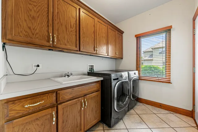 a utility room with sink dryer and washer