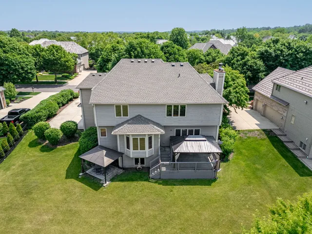 a aerial view of a house with swimming pool garden view and a yard