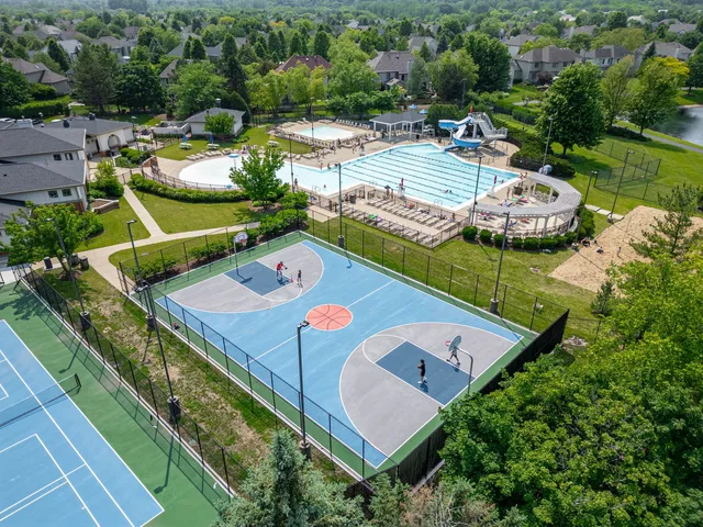 an aerial view of a house with a garden and lake view