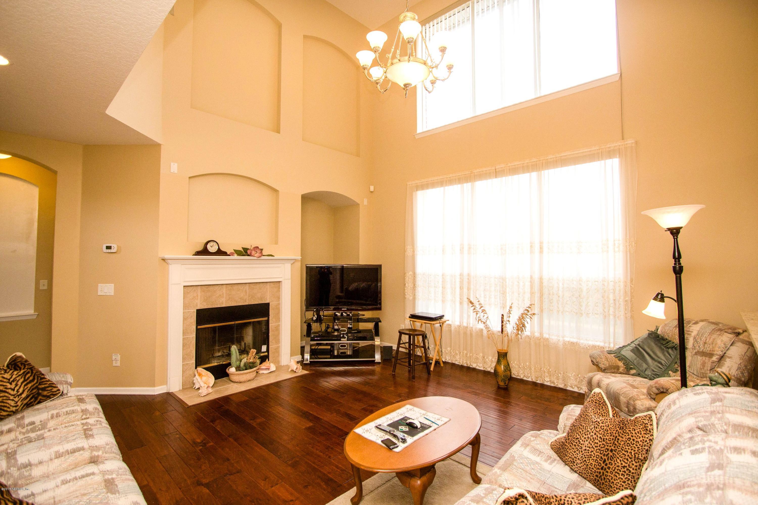 2520 Benjamin Road Jacksonville, FL 32223 - Photo 8 of 33 a living room with furniture fireplace and a table