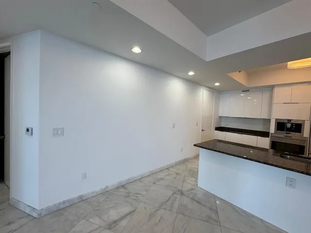 a kitchen with a sink a stove and cabinets