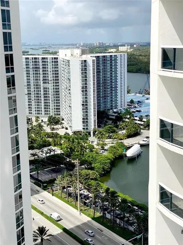 a view of a lake with a couple of cars parked in a yard
