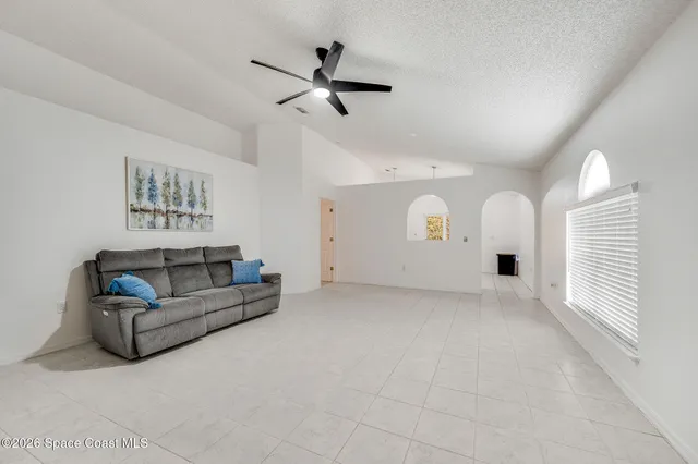a living room with furniture and white walls