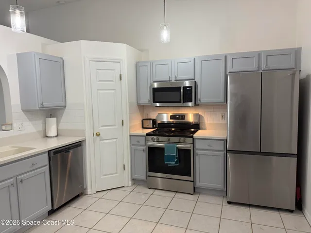 a kitchen with stainless steel appliances granite countertop a refrigerator sink and stove